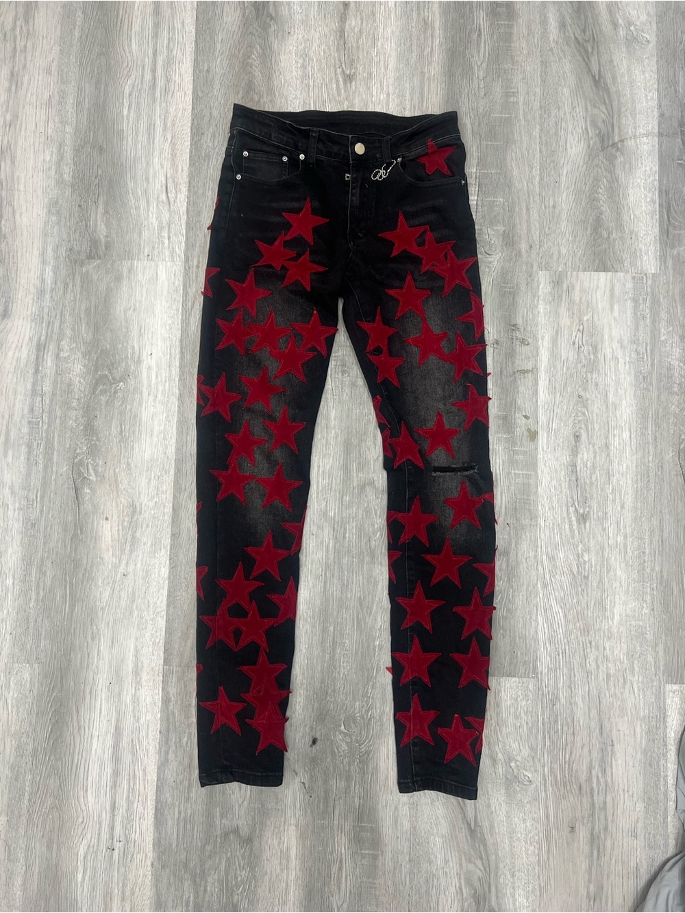 Black Amiri Skinny Jeans with Red Star Appliqués